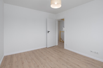 Empty Room with Open Door and Wooden Floor