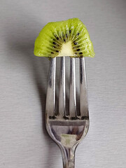 kiwi on a fork
