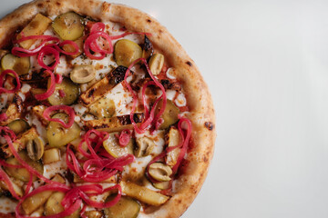 pizza with pickled onions and cucumbers close-up