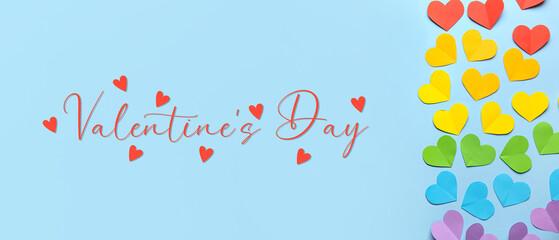 Colorful paper hearts on blue background. Valentine's Day celebration