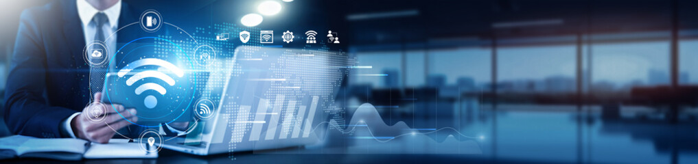 Internet of Things (IOT) specialist using a tablet with a digital interface overlay showing device connectivity, sensor data, and technology graphs networks, real-time analytics, cloud integration.