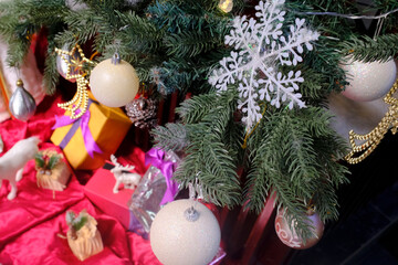Plastic Christmas tree decorated with ornaments and present. Christmas celebration.