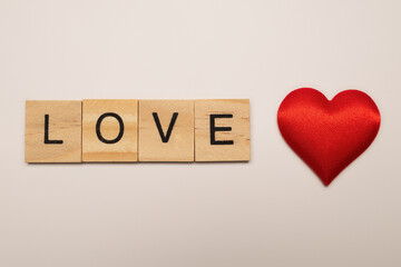  Love message written в wooden blocks. Red heart.