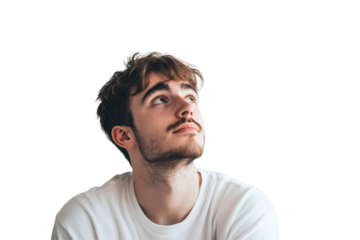 Young man gazing thoughtfully upwards against a pristine white background, reflecting on ideas or inspirations during a moment of introspection