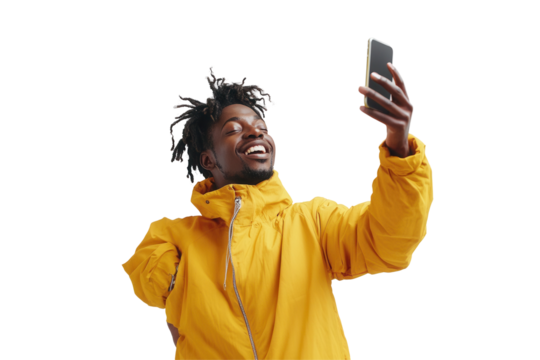 Young man in a yellow jacket smiling while taking a selfie on a smartphone against a plain white background - Powered by Adobe