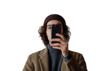 Young man wearing a straw hat and pink denim jacket taking a selfie against a plain white background