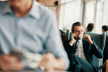 Professional businessman enjoying coffee while sitting in a modern cafe