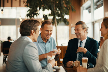 Diverse business people having meeting in modern cafe