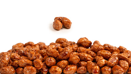 Tasty sweet roasted peanuts isolated on a white background.