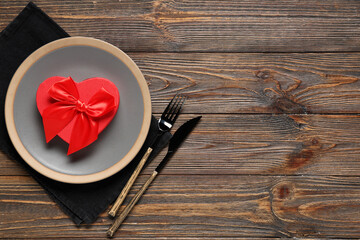 Beautiful table setting with gift box on wooden background. Valentine's Day celebration