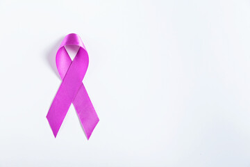 A close-up of a purple ribbon lying on a clean white surface, symbolizing pancreatic cancer awareness. Ideal for healthcare campaigns, advocacy, and support resources.