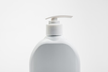 Mockup of white plastic bottle for liquid soap or shampoo with blank label.