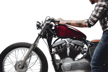 Man in plaid shirt working on a custom motorcycle in a studio with white background showcasing detailed craftsmanship and mechanical precision