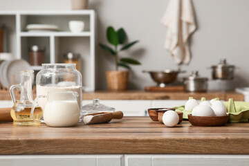 Utensils and ingredients for preparing dough on kitchen counter