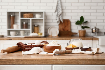 Utensils and ingredients for preparing dough on kitchen counter