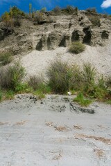 Eroded Cliff with Sparse Vegetation in a Rugged Landscape