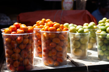 Seriguelas for sale at a market. Fruit source of fiber rich in vitamin C, flavonoids and carotenoids.