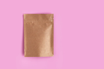 Kraft brown paper empty bags isolated mock up on light pink background. Eco friendly pack with zipper, roasted specialty coffee beans, tea, snack, alternative sample trendy concept. top view, flat lay