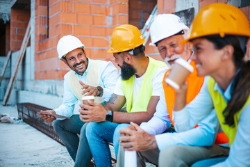 Construction Workers on Coffee Break Smiling and Conversing at Job Site