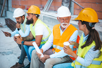 Construction Workers Having a Break at a Worksite, Chatting and Relaxing