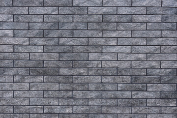 Texture of grey brick wall as background, closeup
