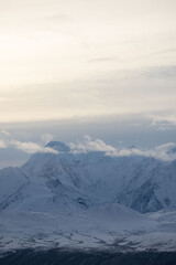Clouds across the top of a snowy mountain on a fall afternoon south of Delta Junctions, Alaska.