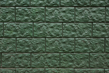 Texture of green brick wall as background, closeup