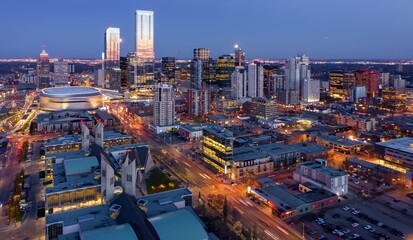 Nighttime aerial view of downtown Edmonton city, showing illuminated buildings, traffic, and the arena. Urban cityscape at twilight., Edmonton, Alberta, Canada
