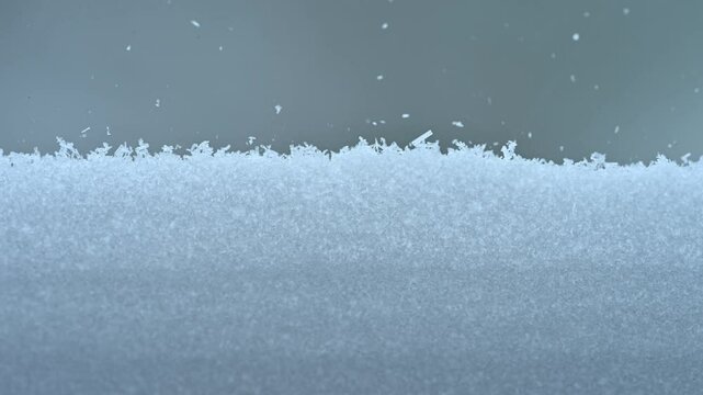 Snow falling on the window sill, snowflakes piling up, macro, UHD, 60 fps