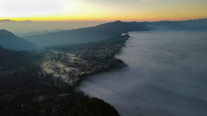 Fog creating a mystic scenery at sunrise, seen from above
