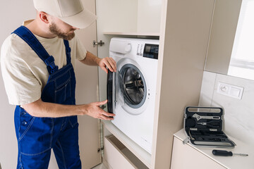 Maintenance of a modern washing machine in a stylish laundry room