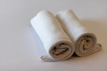 towels on the bed in the luxury hotel room ready for tourist travel.