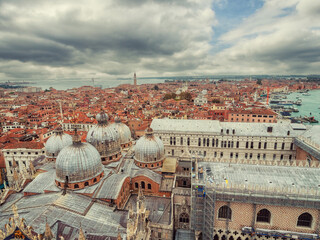 A cityscape of Venezia, Italy, from a high view point. The sky is cloudy and the buildings are old...