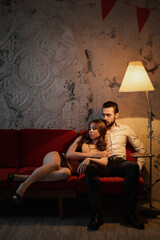 Intimate connection between couple relaxing on a cozy couch in a softly lit room