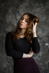 Captivating portrait of a woman expressing grace and elegance in a thoughtfully designed studio setting