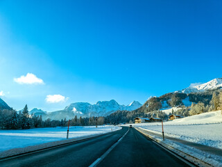 Mountain road in winter in Austrian Alps with snow