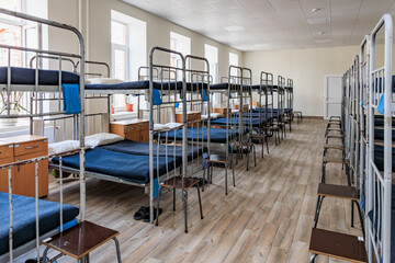 Empty dormitory room with bunk beds in daylight