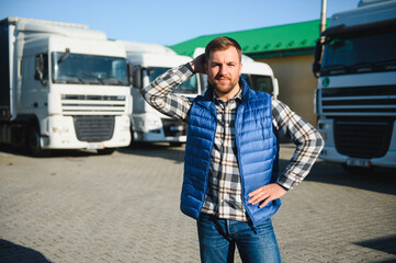 Portrait of confident truck driver on parking lot. Copy space