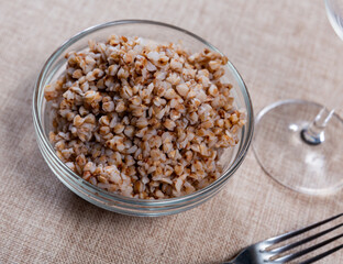 Plate contains portion of boiled buckwheat, traditional Ukrainian dish, side dish for meat and independent meal porridge