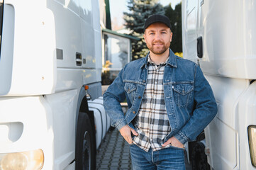 Portrait of young bearded trucker standing by his truck vehicle. Transportation service. Truck...