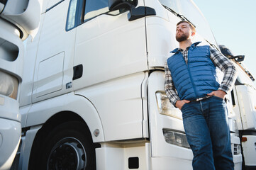 Portrait of confident truck driver on parking lot. Copy space