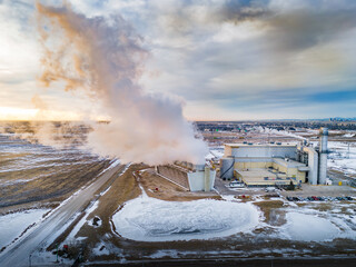 Power generation plant with steam turbines producing electricity during winter near Calgary Alberta...