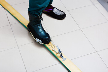 Obraz premium New cable ski bindings with free heel, similar to early bindings called Kandahar, at time of installation and adjustment.