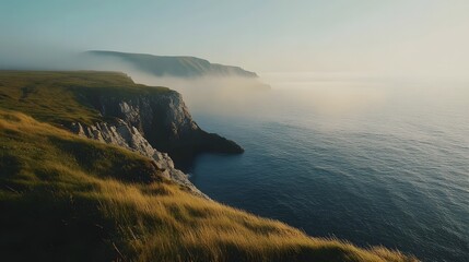 Coastal cliffs shrouded in morning mist, tranquil ocean view, ideal for travel brochures