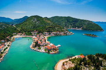 Fototapeta premium Blace Coastal Village Aerial View, Southern Croatia. Stunning Lagoon Surrounded by Scenic Hills and Clear Adriatic Waters