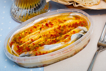 Herring preserves in a plastic jar. High quality photo