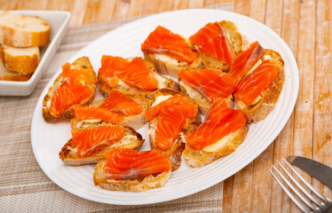 Closeup of tasty sandwiches with bread and fresh sliced salmon fillet