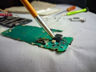 Cleaning Electronic Circuit Board with Brush for Mobile Phone Repair