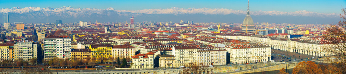 Fototapeta premium Panorama of Turin against backdrop of snowy Alps in sunny day, Italy