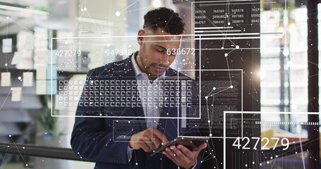 Image of digital data processing over biracial businessman using tablet in office